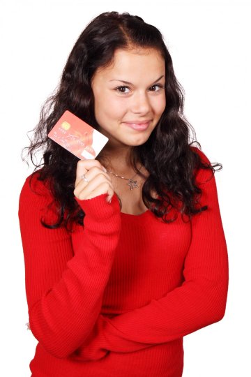 A picture of a girl holding a credit card.